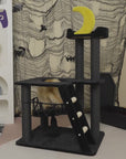 A cat playing on the various platforms of the Nightfall Cat Tree